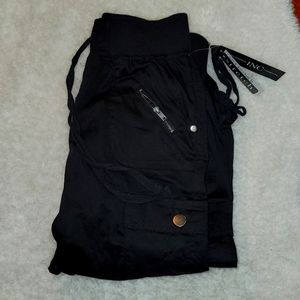 Black light weight capris with sliver detail and lots of pockets. Adjust.string